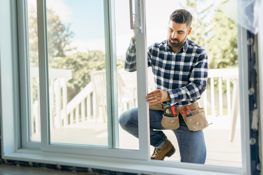 expert working on impact window and doors installation in a house